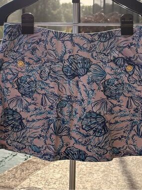 Lilly Pulitzer Madison Skort is a pink and blue featuring a seashell pattern.